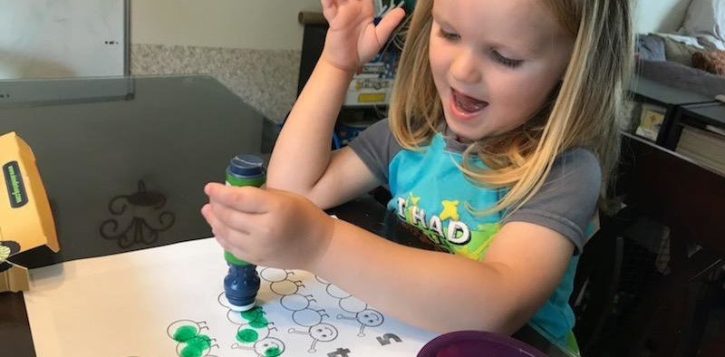 reviewer&#x27;s photo of their child using the dot marker