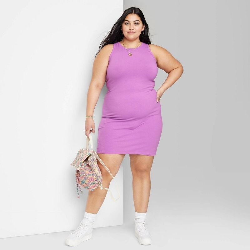 A model wearing a purple dress