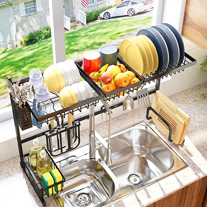 the drying rack full of stuff over the sink