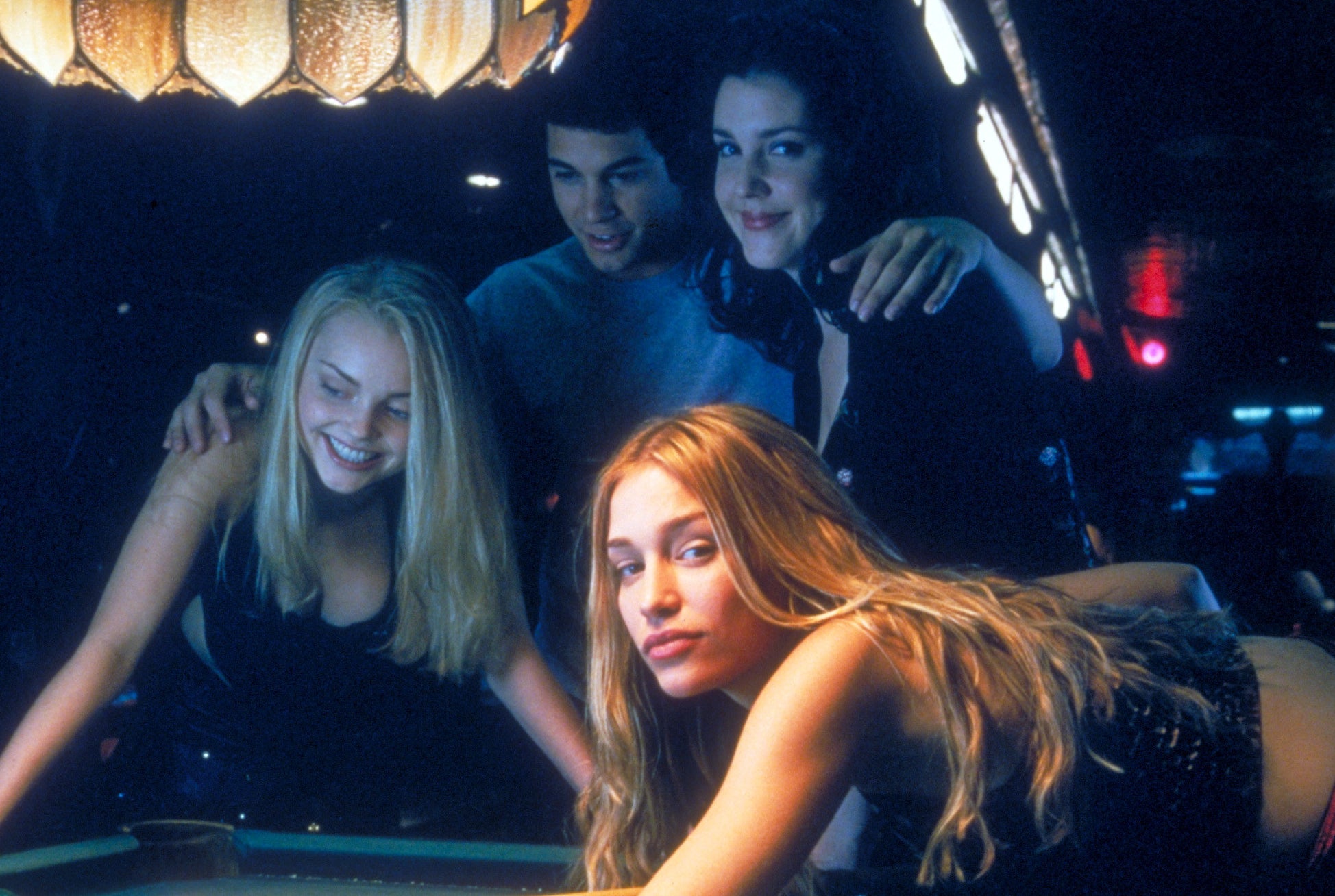Melanie poses at a pool table with her co-stars