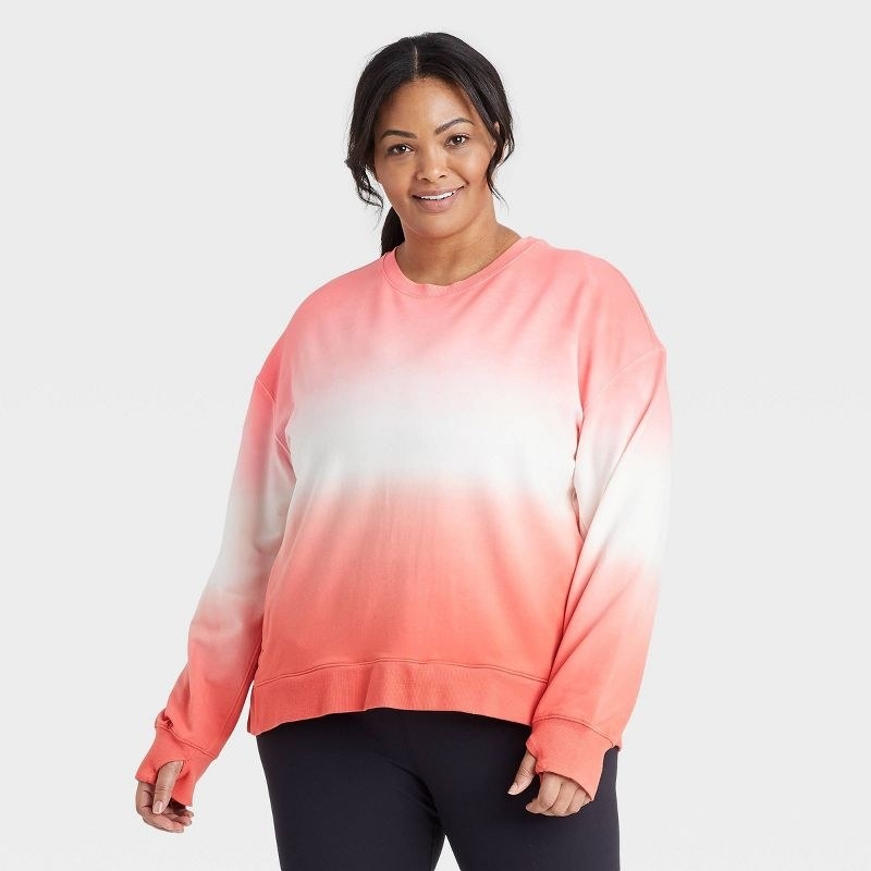 A model wearing a pink and white sweater