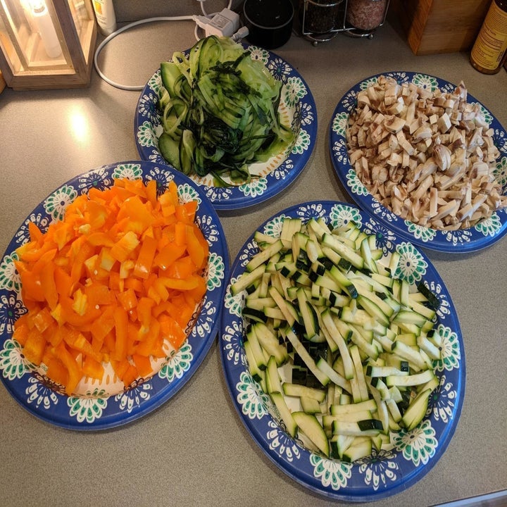 A reviewer's plates full of chopped veggies