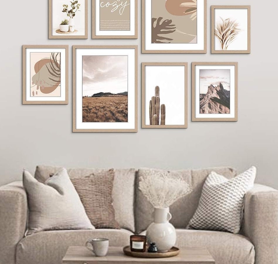 a set of frames over a couch in a living room