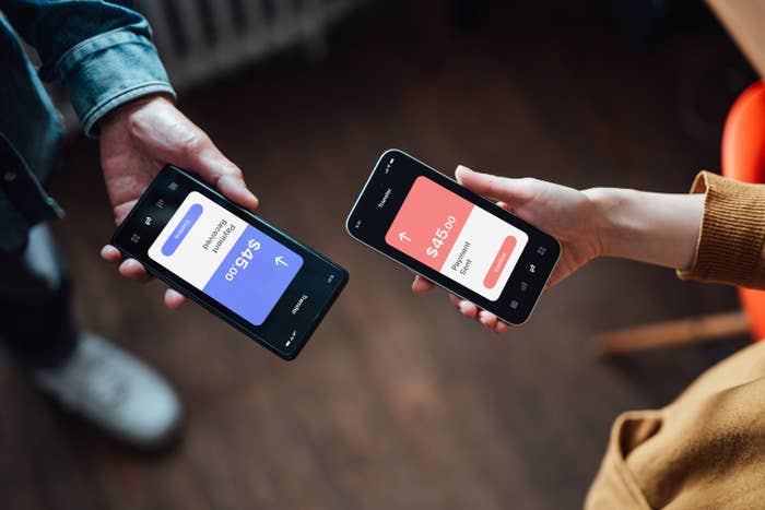 Couple transferring money to one another on phones