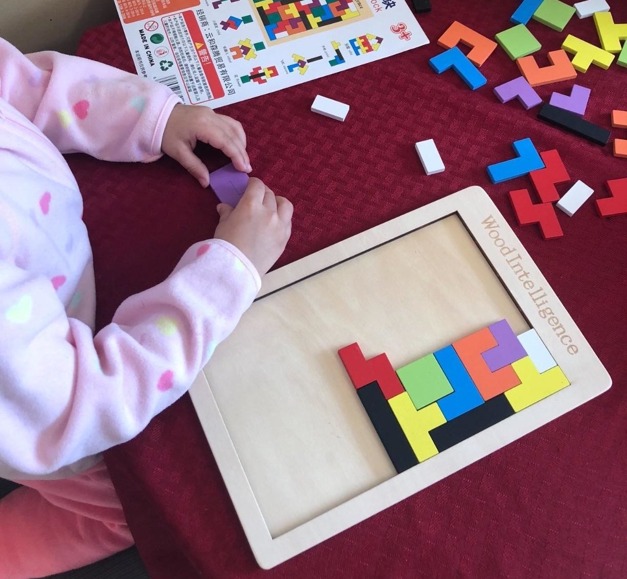 kid playing with block puzzle
