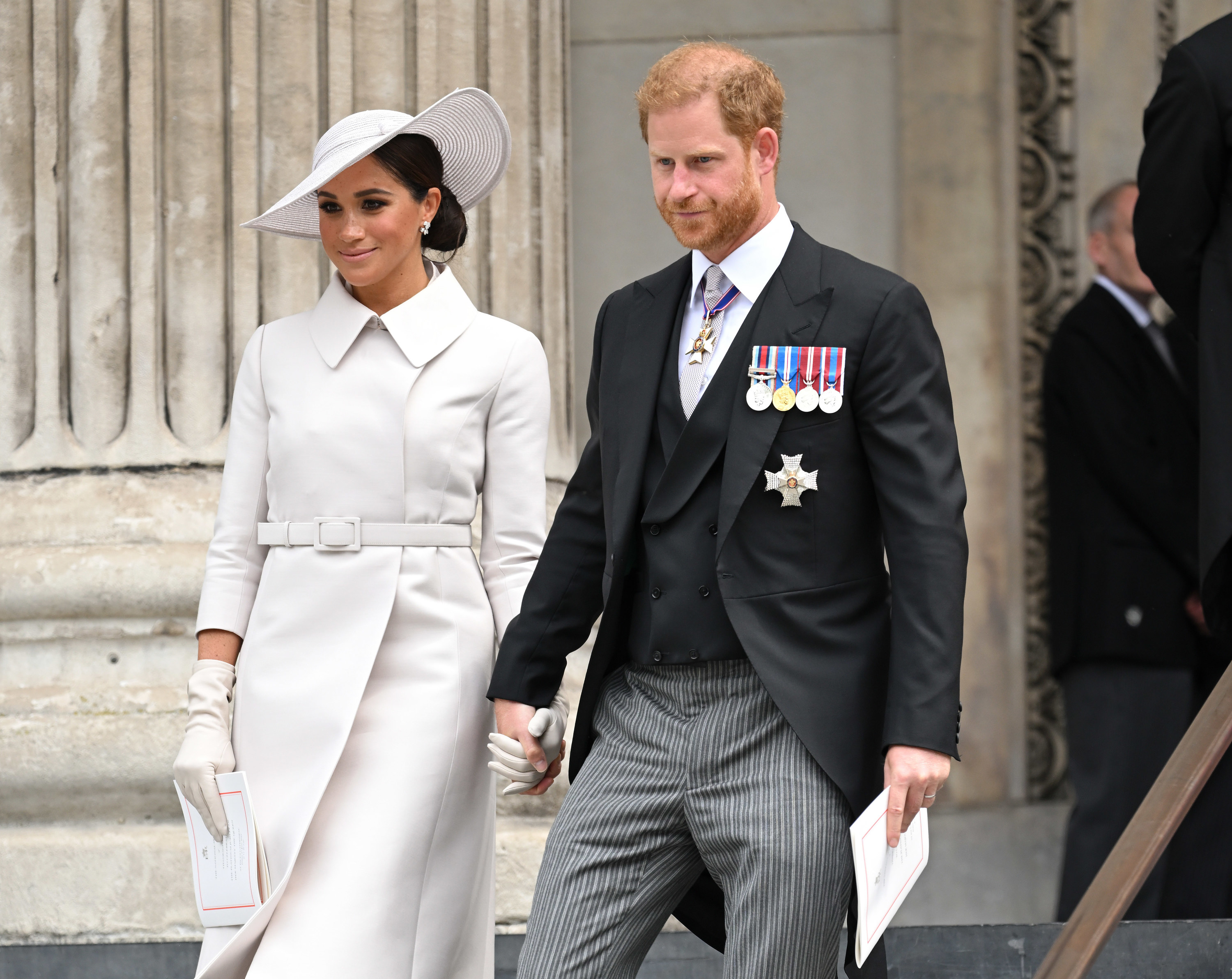 Meghan Markle and Prince Harry walking while holding hands