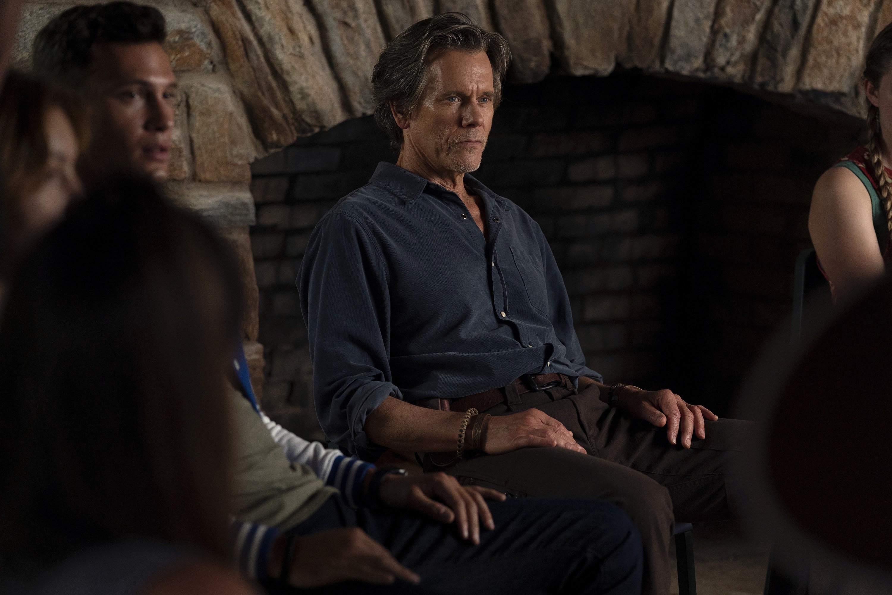 Kevin Bacon sitting with a group.