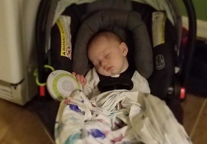 reviewer&#x27;s photo of baby sleeping with portable noise machine