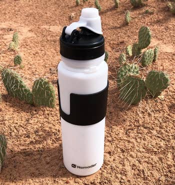 A reviewer's white bottle unrolled in a desert 