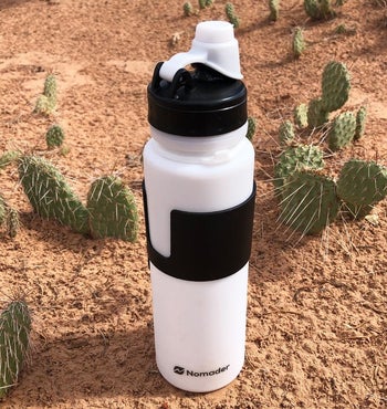 A reviewer's white bottle unrolled in a desert 