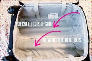 A photo of the space between the metal bars in a rolling suitcase