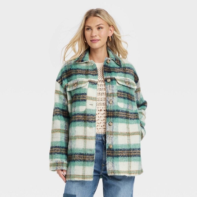 a model wearing the green and white plaid shirt jacket