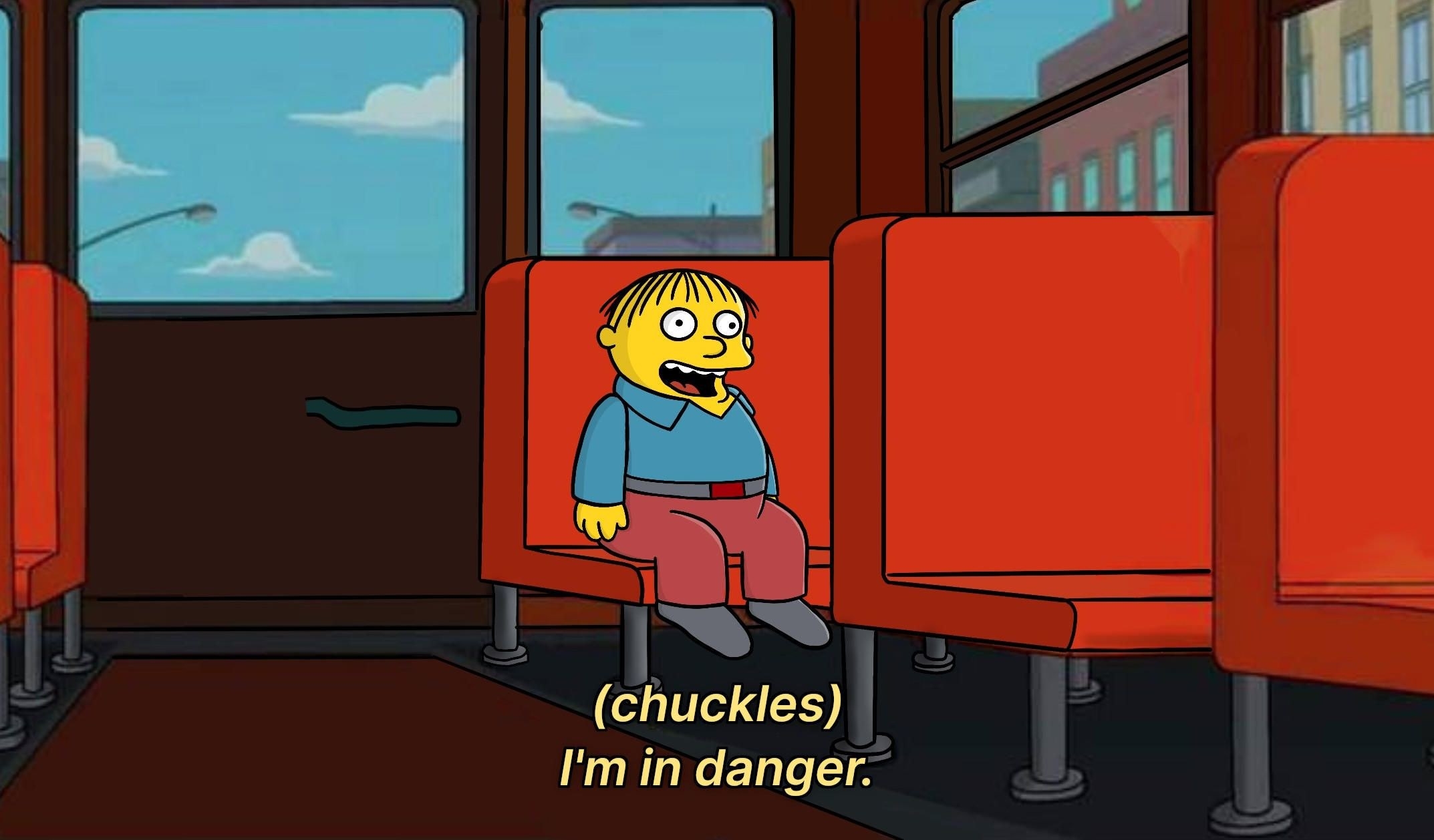 A screencap of the Simpsons, Ralph Wiggum sits on an empty school bus, the caption reads &#x27;(chuckles) I&#x27;m in danger&#x27;
