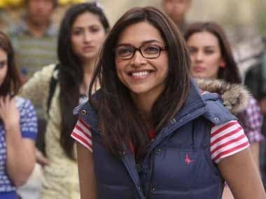 A bespectacled Naina smiles