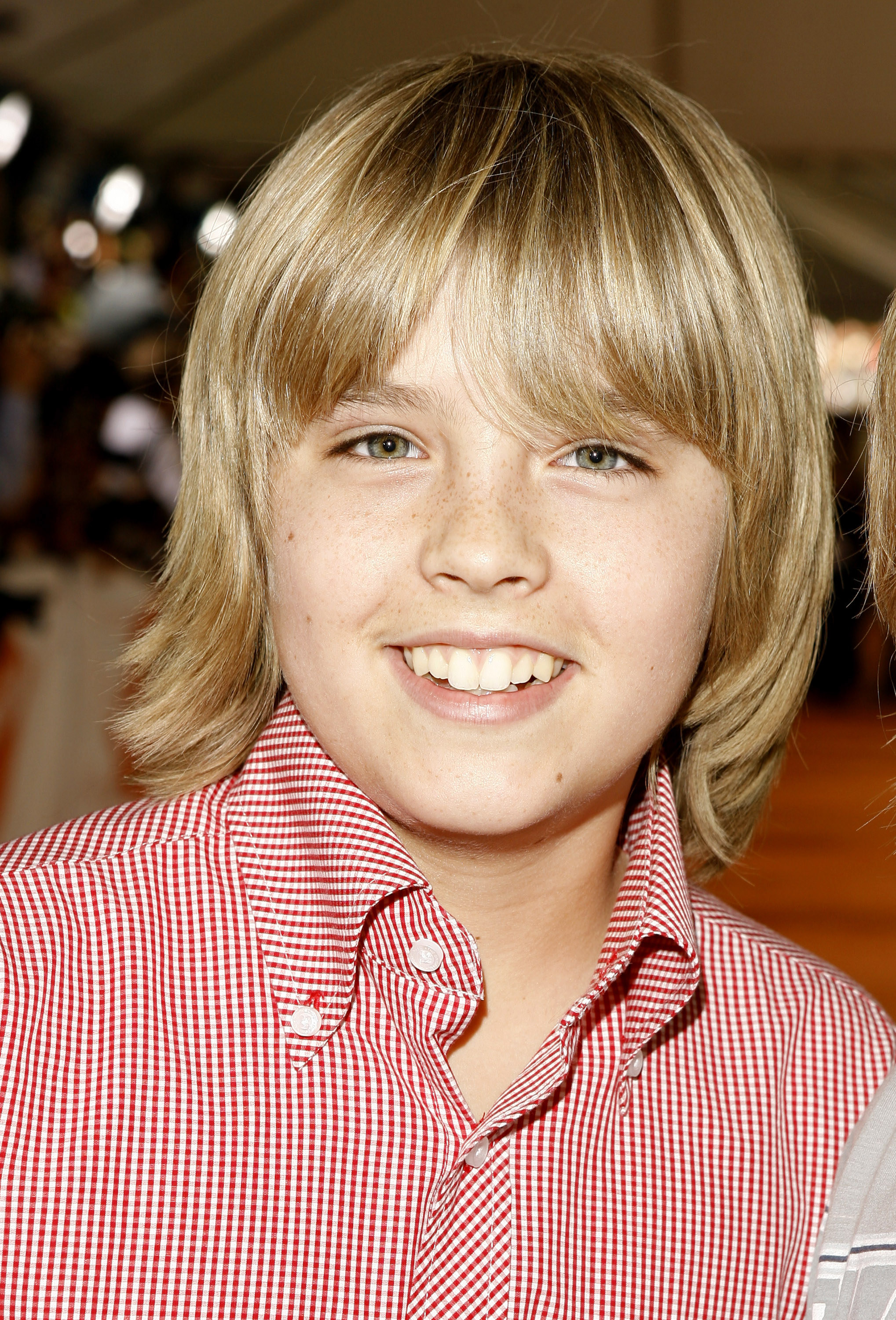 Cole Sprouse smiling at a red carpet