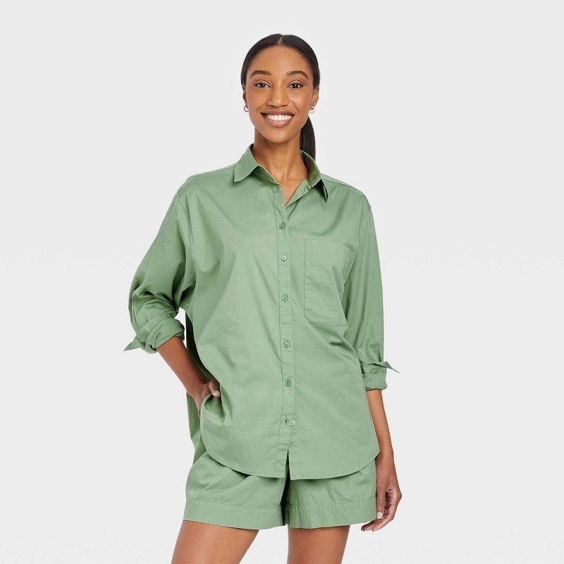 a model wearing the green button down