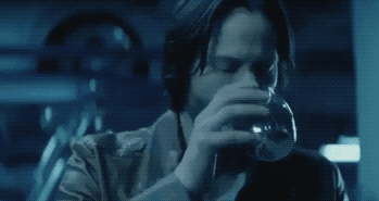GIF of Keanu Reeves having a drink