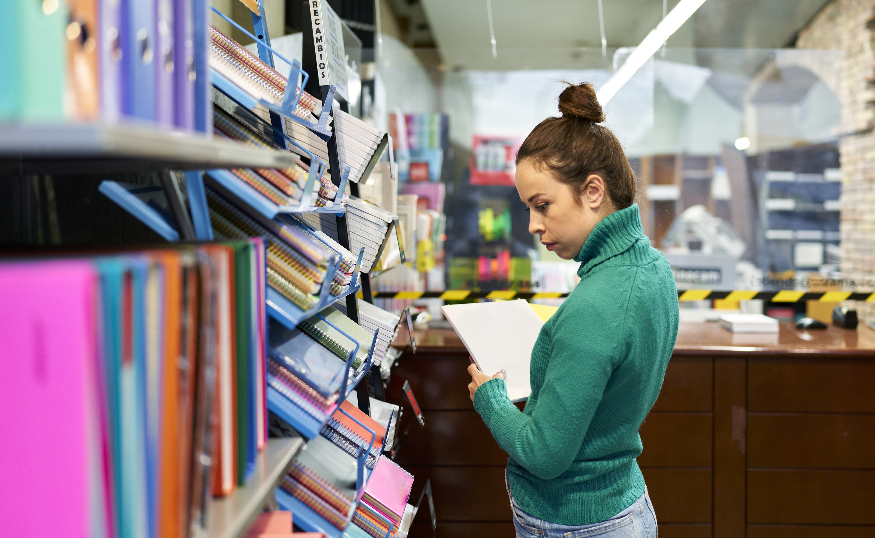 woman shopping for notebooks and binders