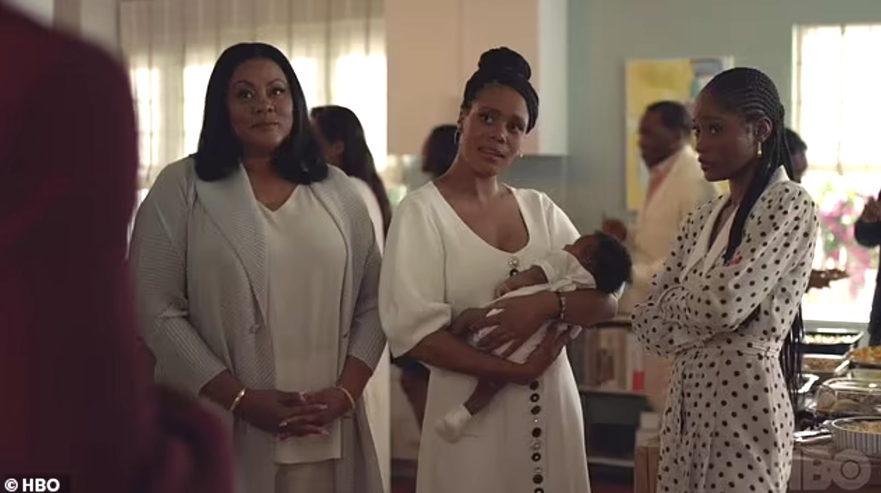 Keke Palmer in insecure standing in a kitchen with two other women and baby