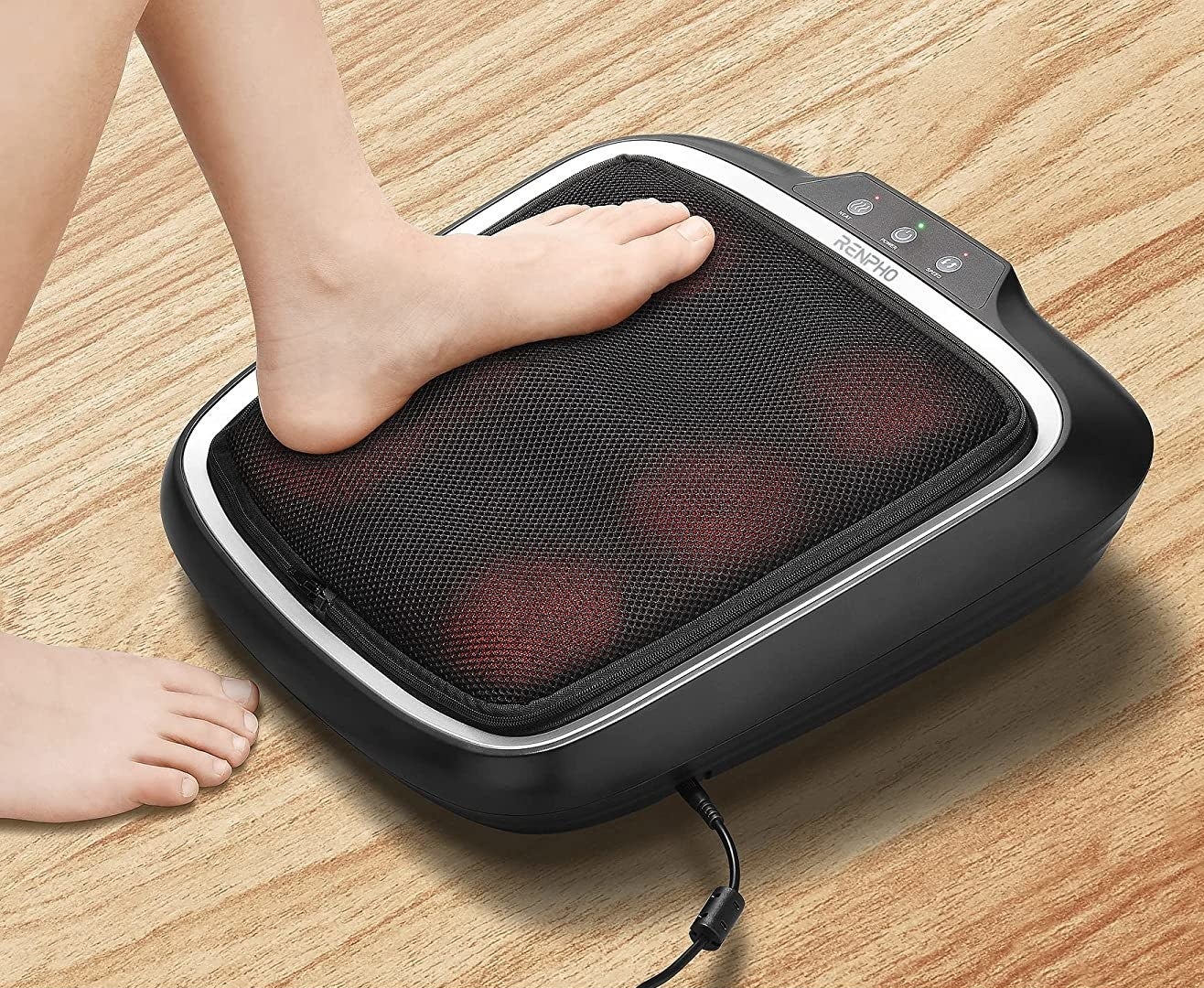 A person putting their foot on the massager