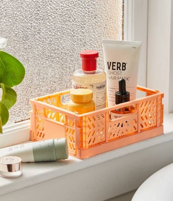 a vibrant storage crate with toiletries inside of it