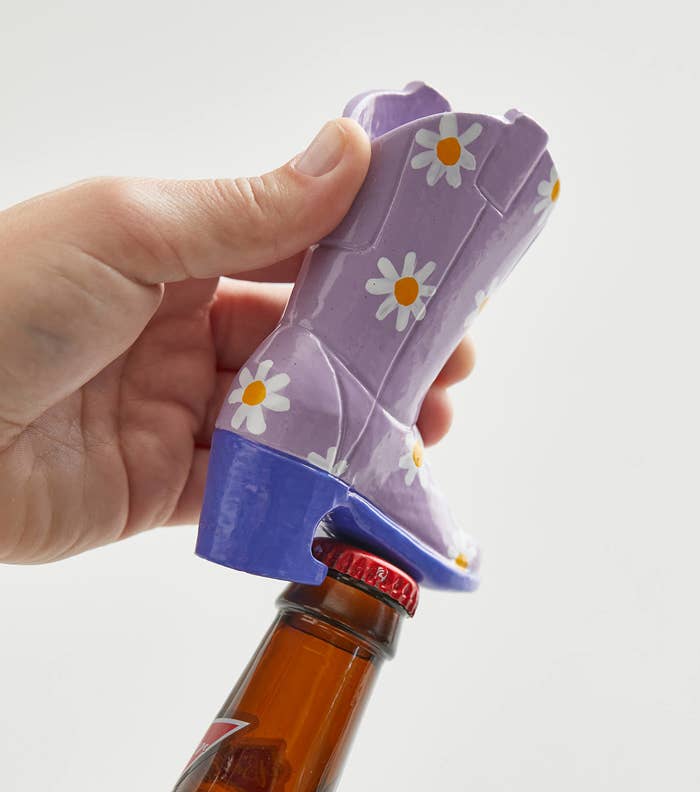 a cowboy-boot bottle opener with tiny daisies painted on it