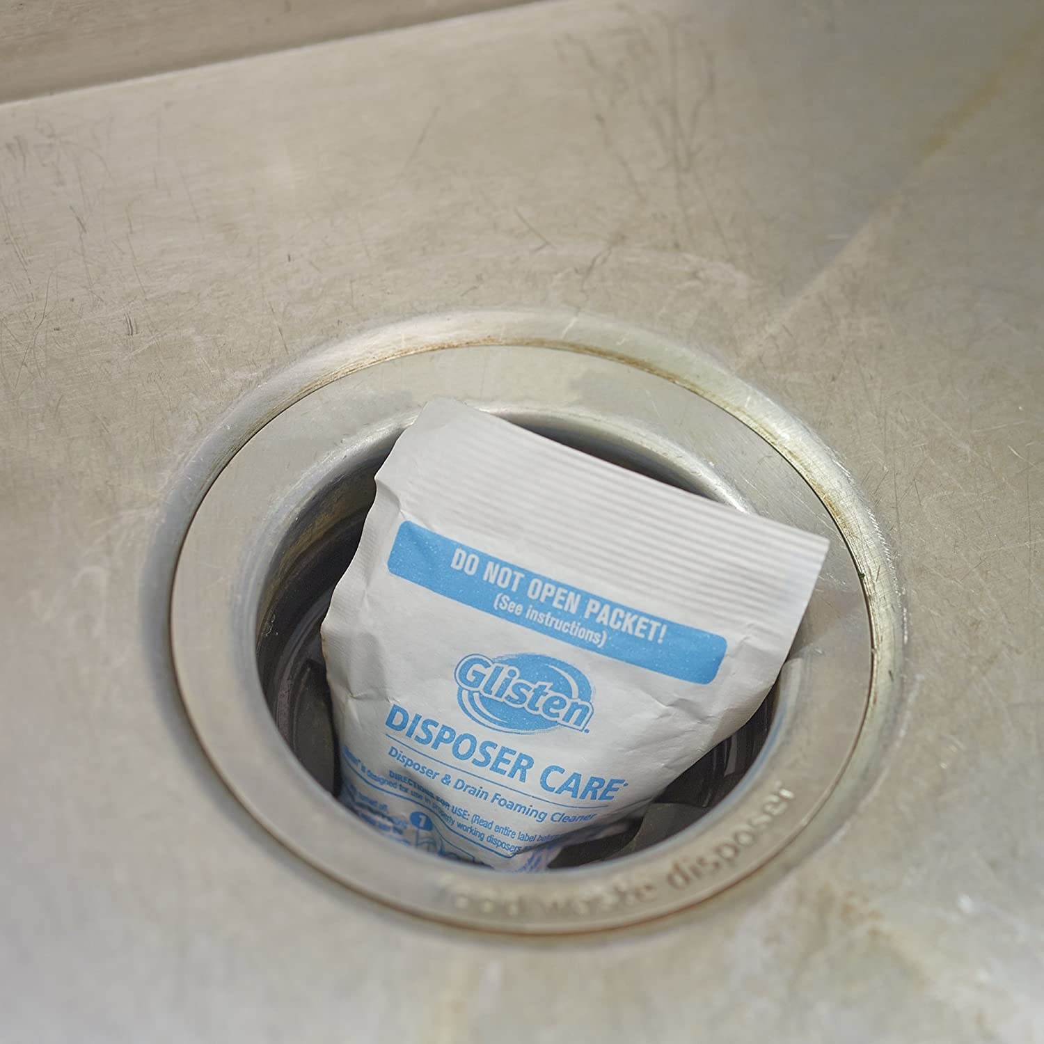 The foaming disposal cleaning pack resting in a garbage disposal drain of sink