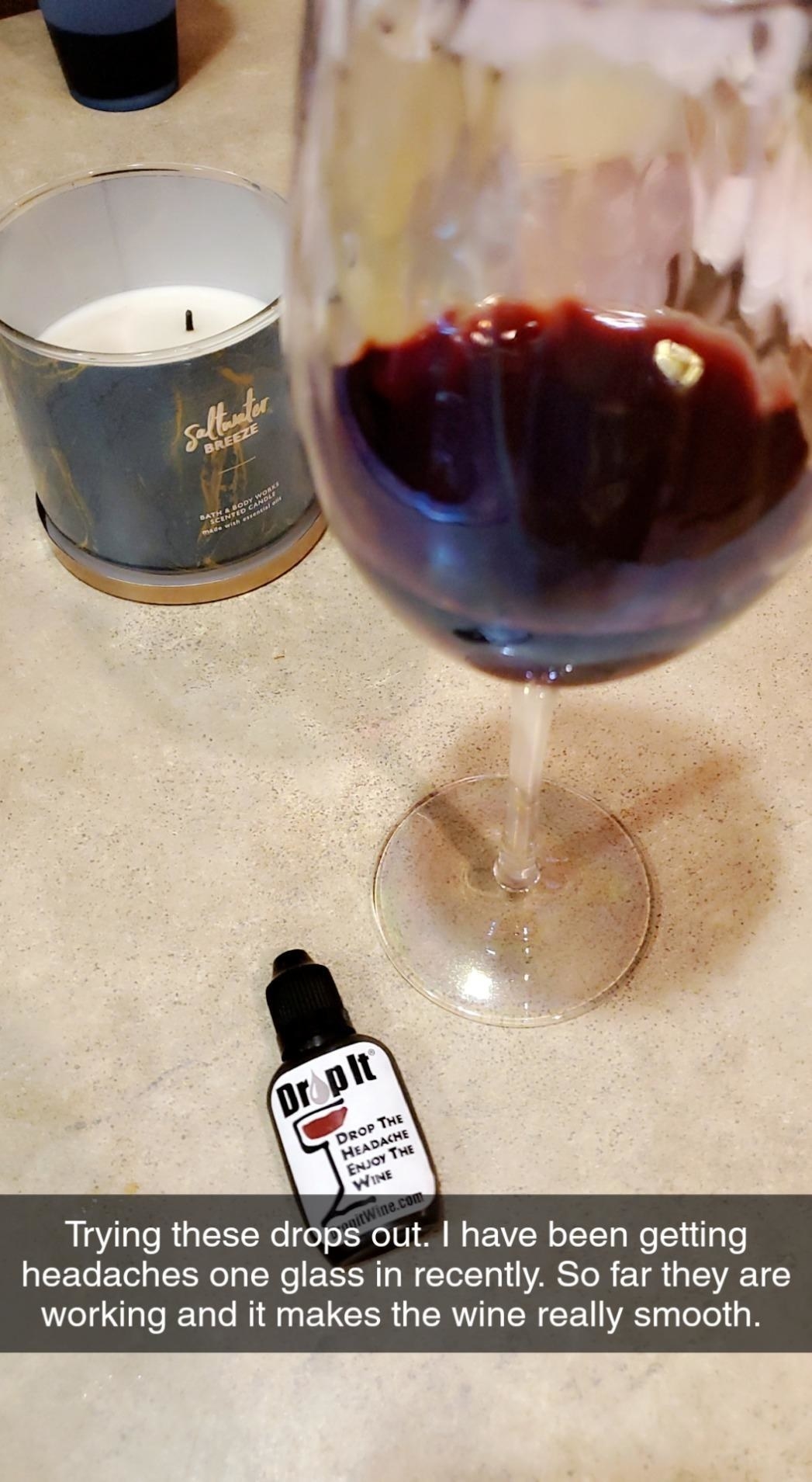 Reviewer&#x27;s photo showing glass of red wine and Drop it bottle on counter. Photo captioned by reviewer &quot;trying these drops out. I have been getting headaches one glass in recently. So far they are working and it makes the wine really smooth.&quot;