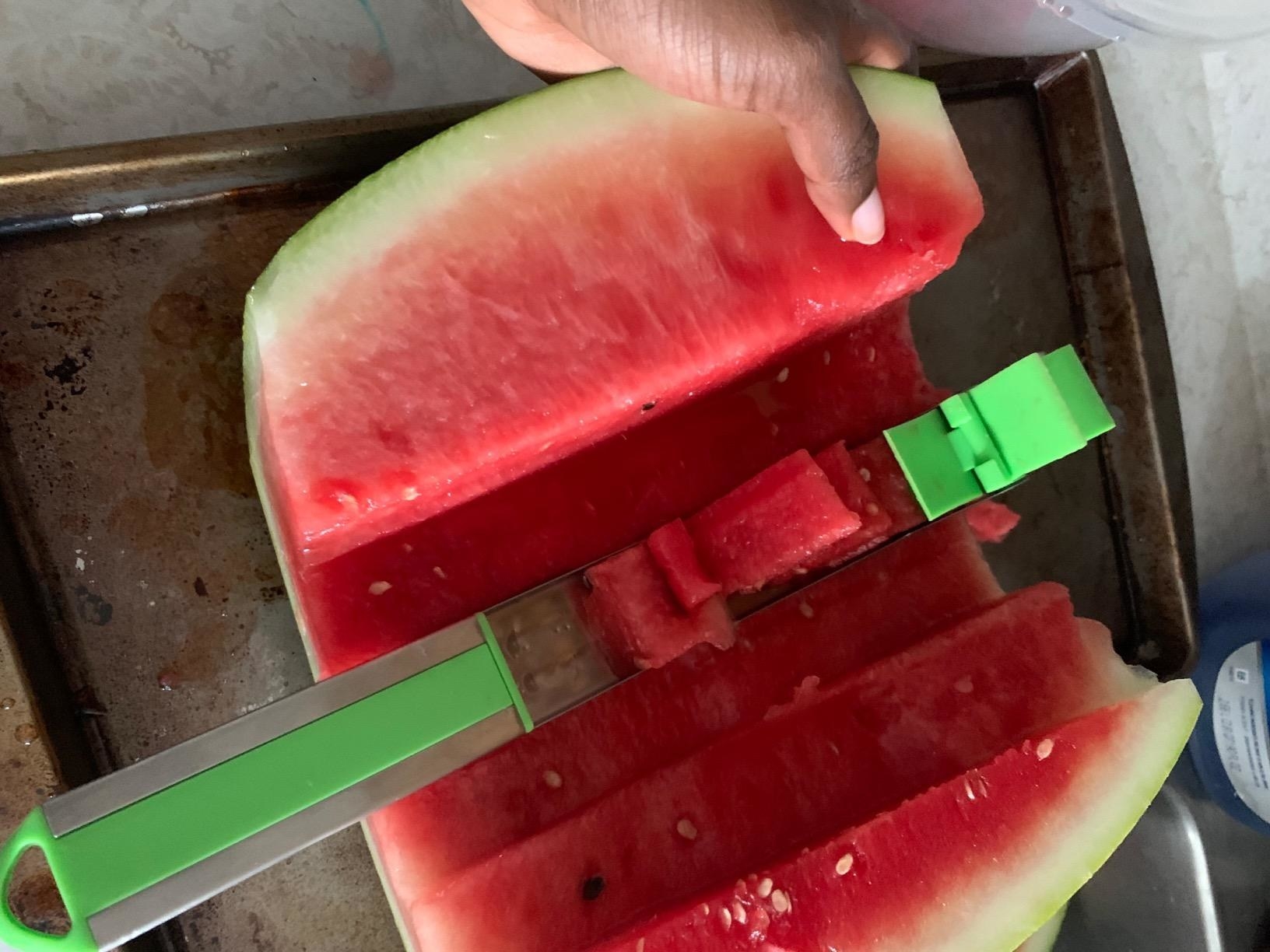 Reviewer showing tool being used to slice watermelon