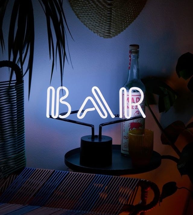 a neon sign that says bar