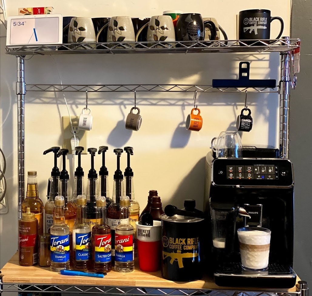 reviewer&#x27;s photo of the espresso machine sitting on their counter making latte