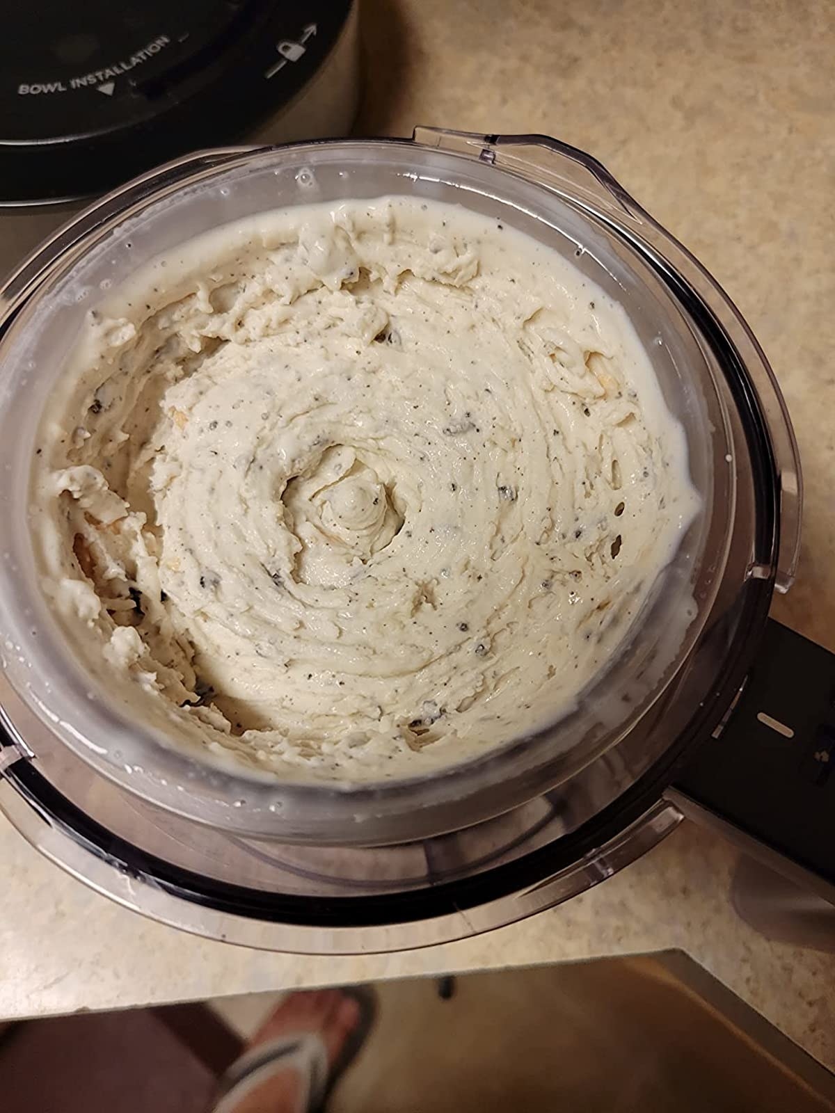 Reviewer&#x27;s photo of the ice cream maker whipping up creamy and thick cookies n cream ice cream