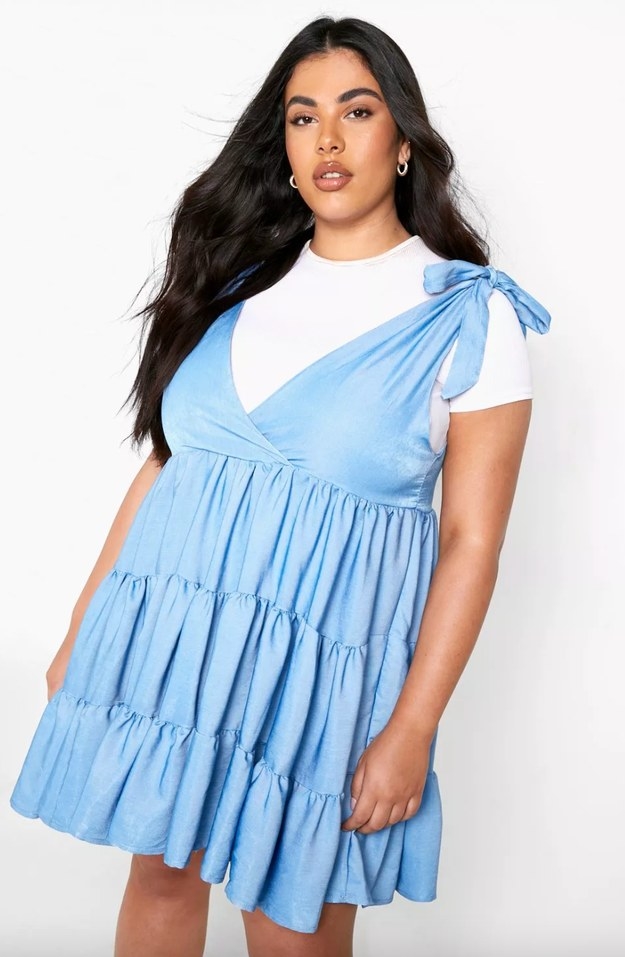 model wearing blue dress over white tee