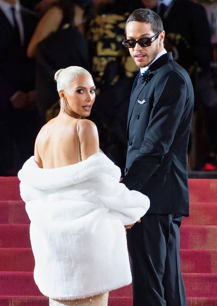 Kim Kardashian and Pete Davidson walking up the steps of the MET Gala