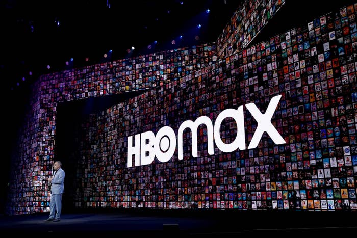 A person on stage in front of the HBO Max logo on a large screen