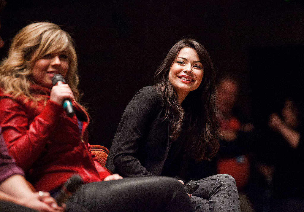 miranda and jenette sitting on a stage