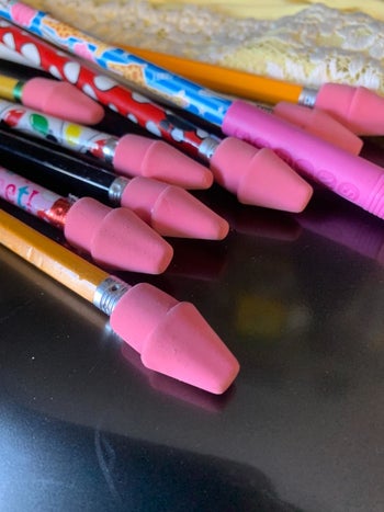 reviewer's photo of the cap erasers fitted on pencils
