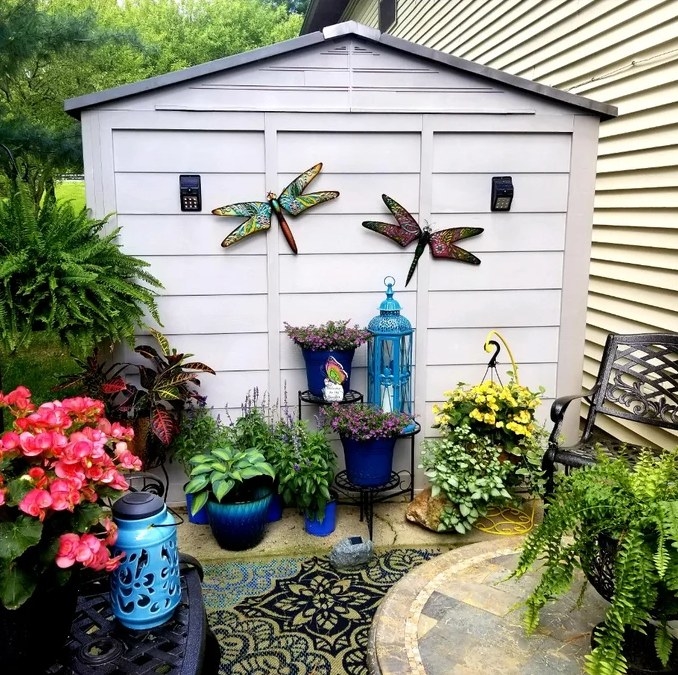 A reviewer&#x27;s image of the dragonfly outdoor wall art
