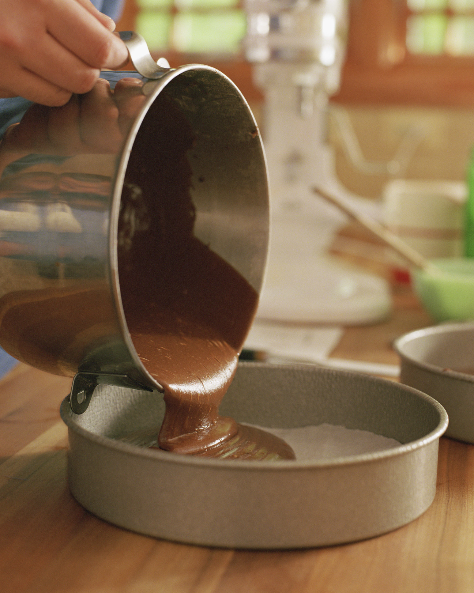 Cake batter is poured into a cake pan