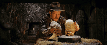 Indiana Jones about to swap a bag of rocks for a golden statue in &quot;Raiders of the Lost Ark&quot;