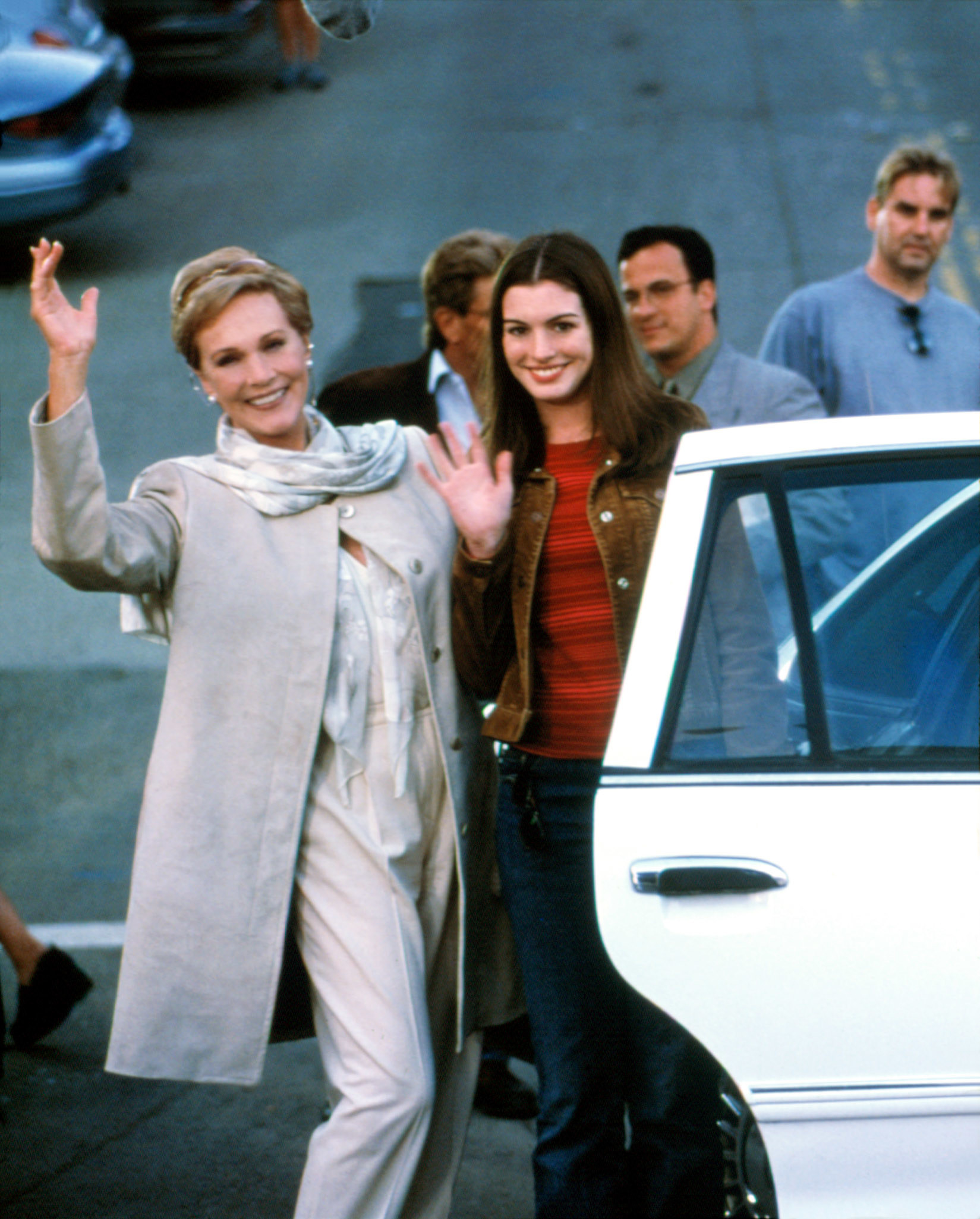 Julie and Anne waving next to a car