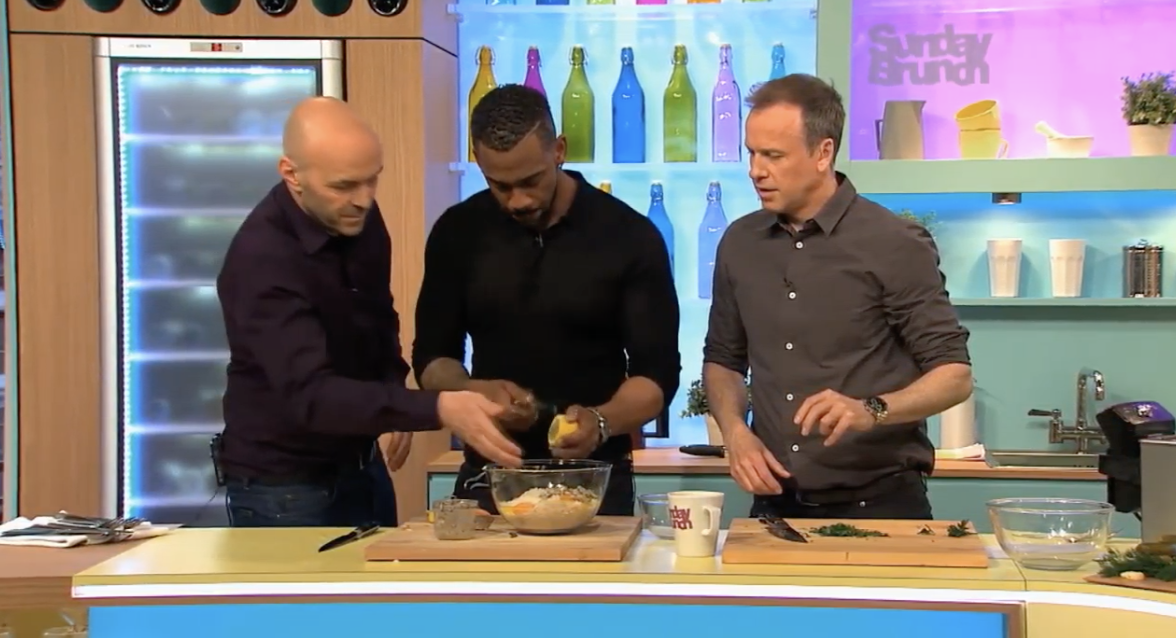richard blackwood zesting a lemon with help from the two presenters