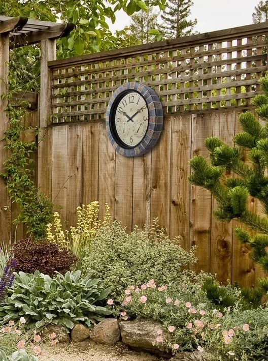 The weather station clock mounted onto a wooden fence
