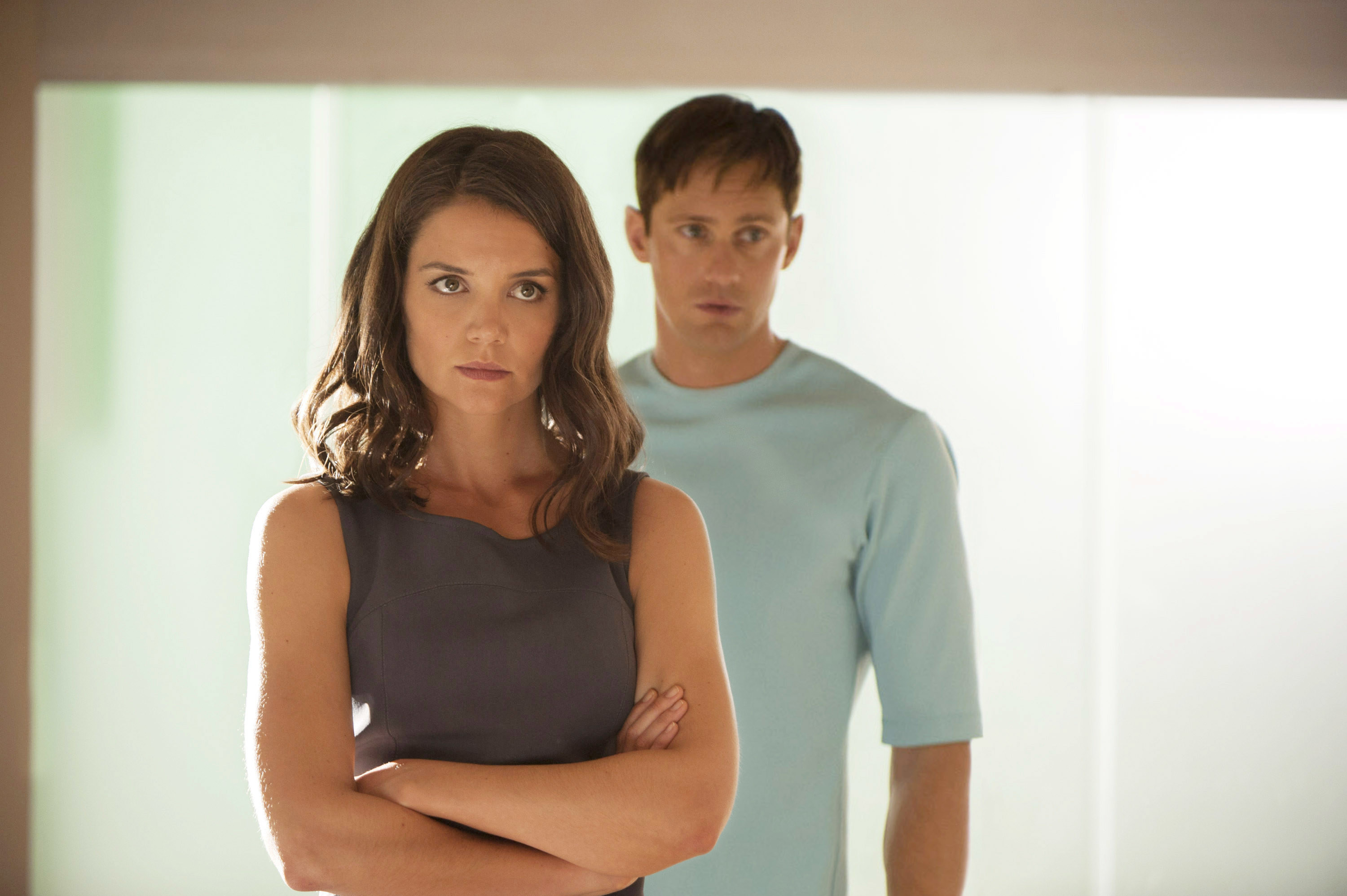 Katie Holmes as Jonas&#x27;s mother with her arms folded and Alexander Skarsgård as his father behind her