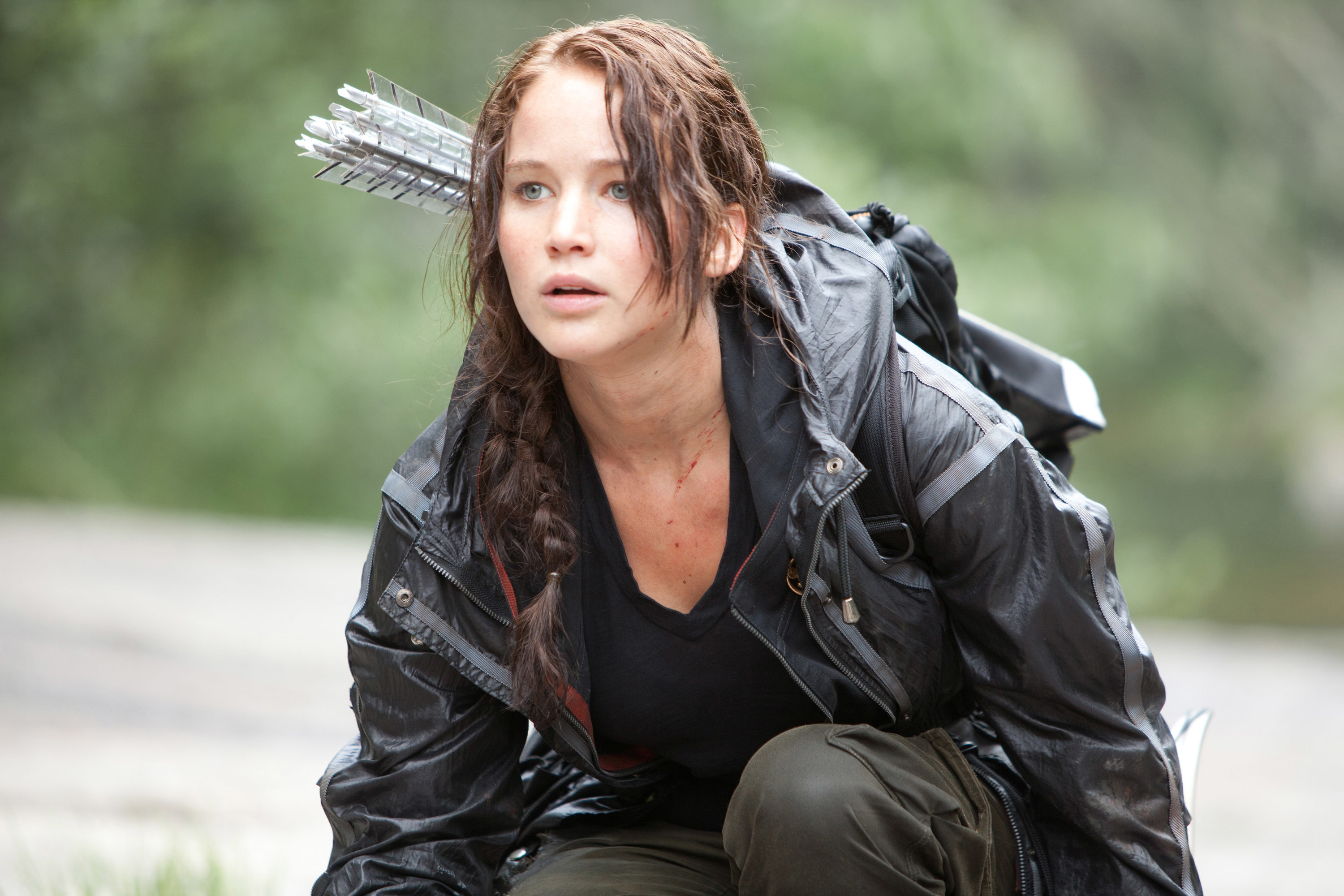 Jennifer Lawrence as Katniss crouching down