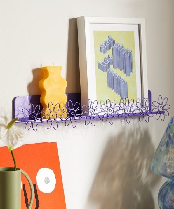 a flowery ledge shelf mounted on a wall