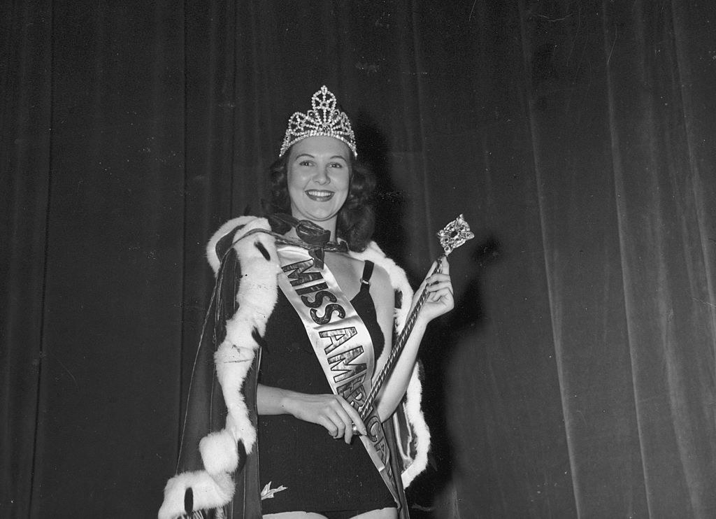 Frances Burke smiling wearing her robe and crown