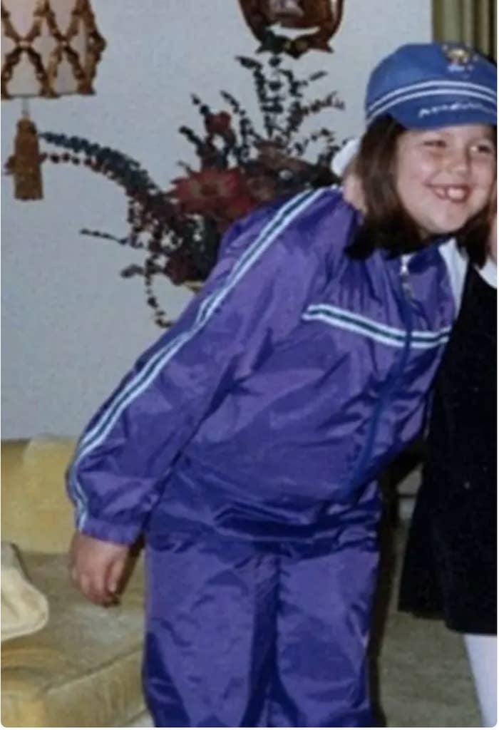 A little girl in a purple jumpsuit