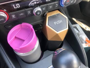 reviewer pic of the same trash can in a car cup holder
