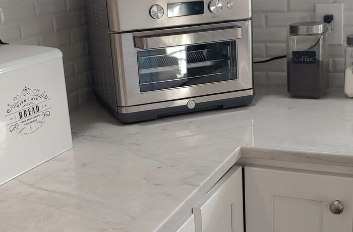 a reviewer photo of the toaster oven air fryer on a kitchen counter